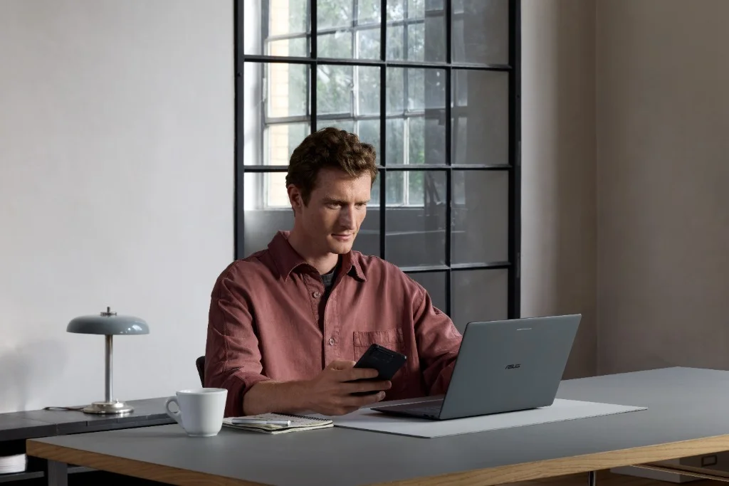User working on ASUS Googlebook 14 with Android phone handoff