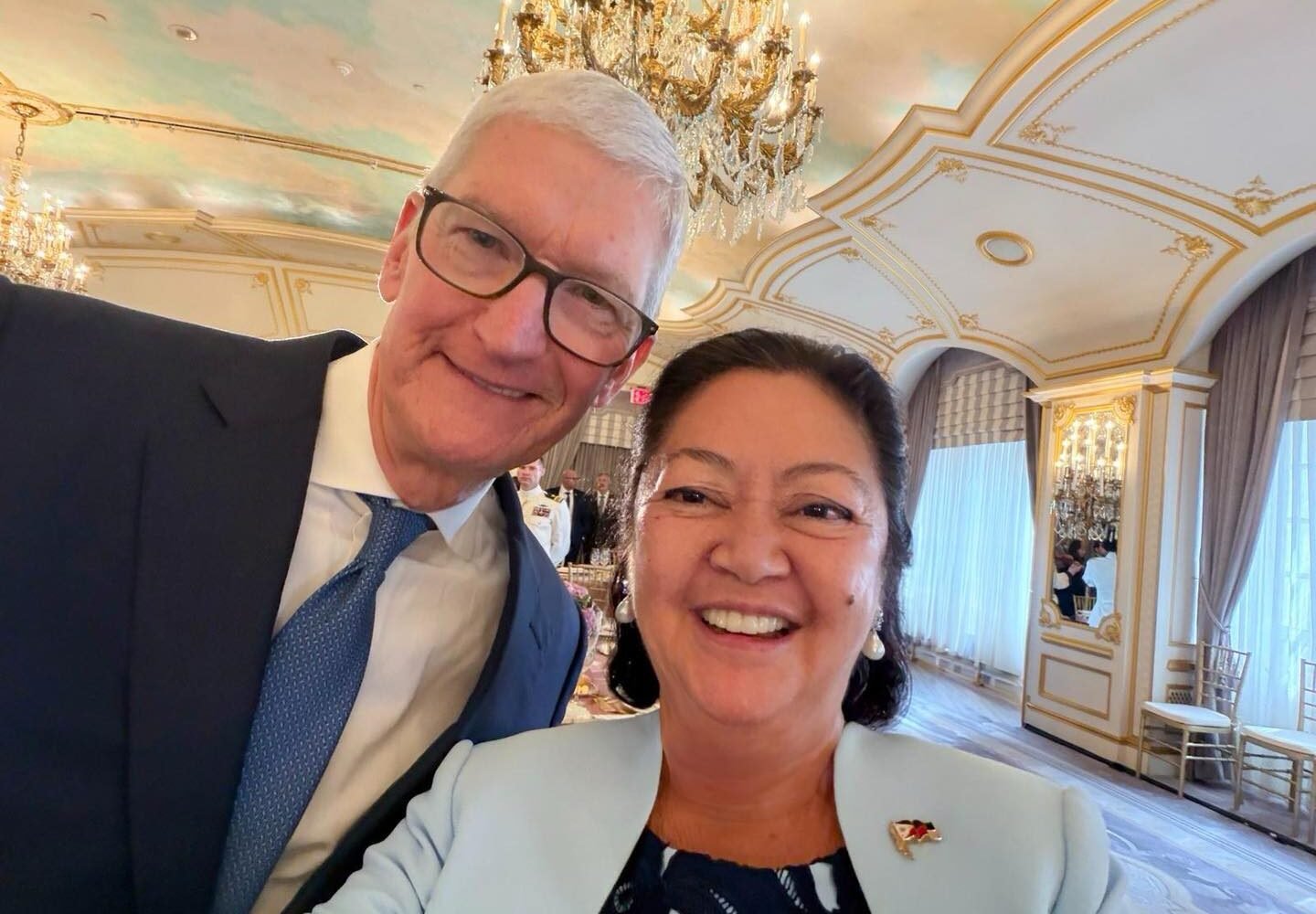 First Lady Liza Marcos taking a selfie with Apple Executive Chairman Tim Cook holding the foldable iPhone Duo