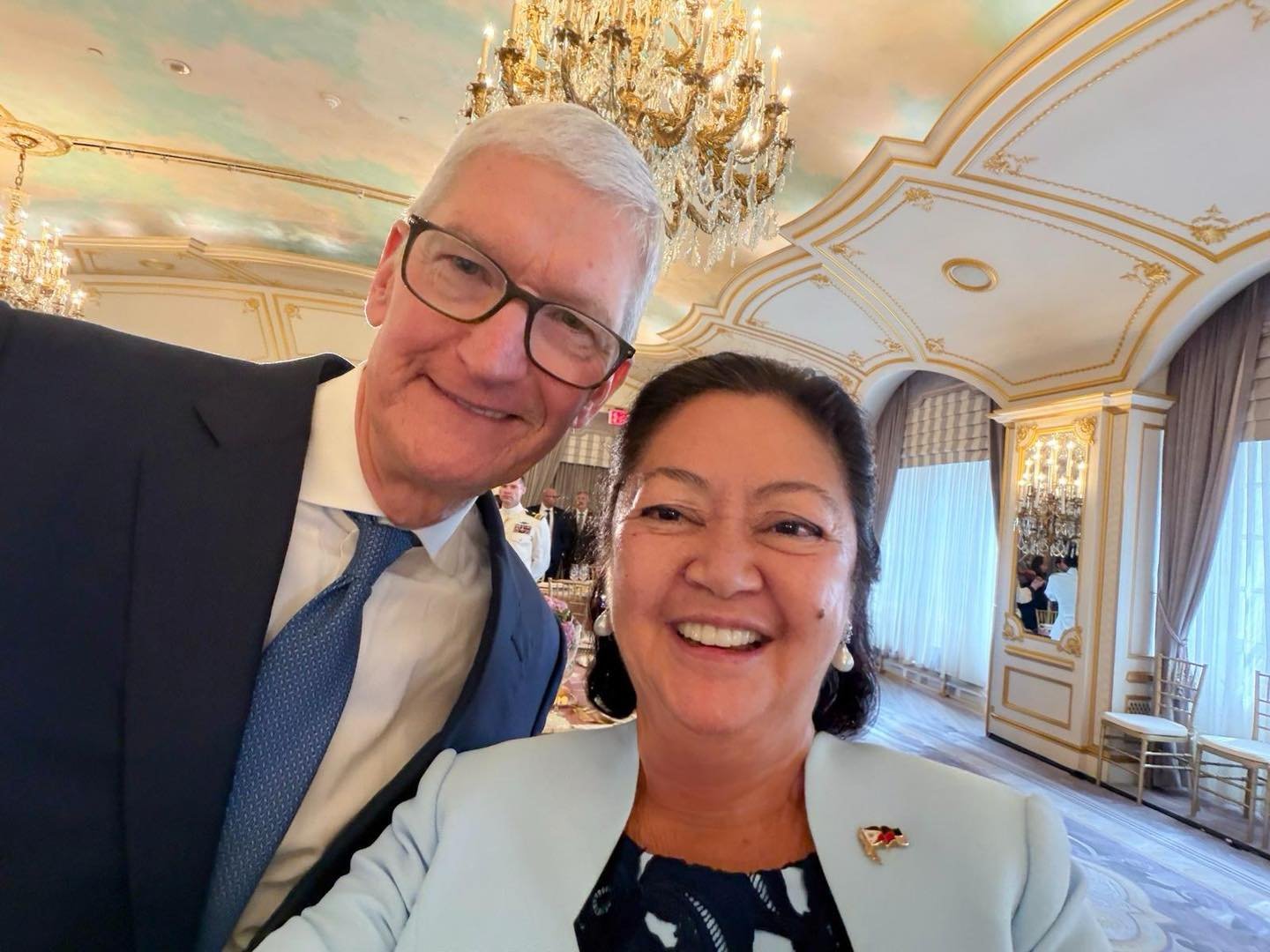 First Lady Liza Marcos taking a selfie with Apple Executive Chairman Tim Cook holding the foldable iPhone Duo