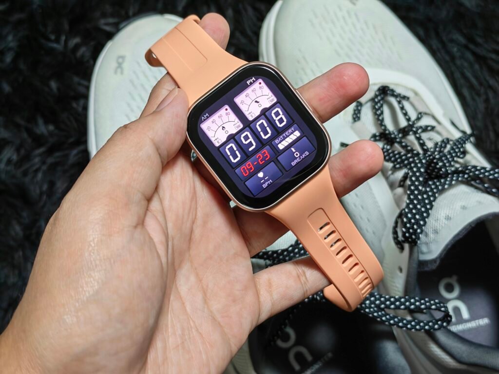Holding a smartwatch against a white running shoes