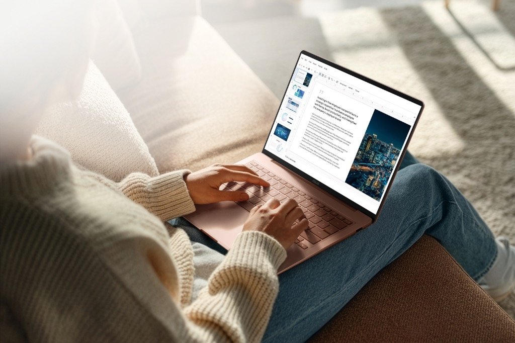 ASUS Zenbook 14 laptop in Komodo Coral with Ceraluminum lid in use