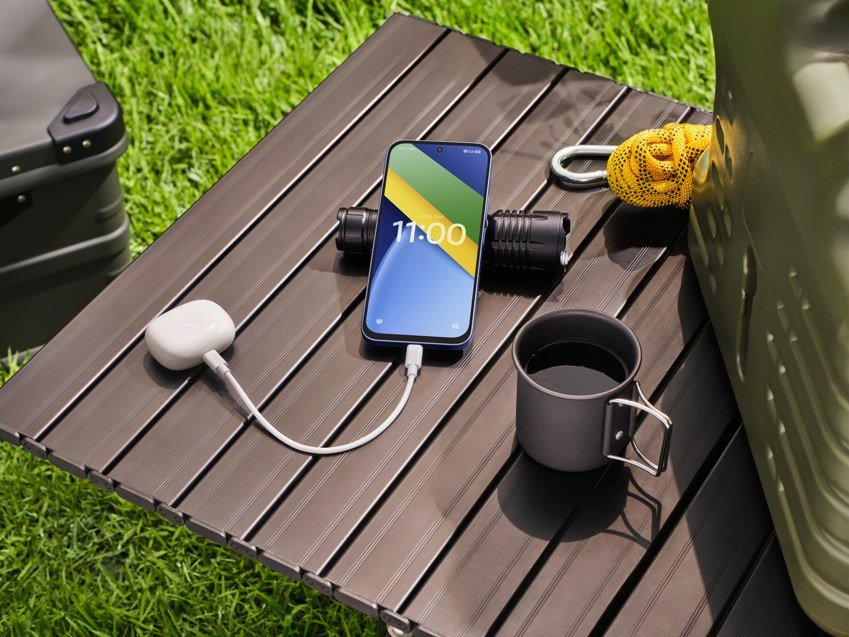 POCO C95 Pro smartphone reverse charging earbuds on an outdoor table